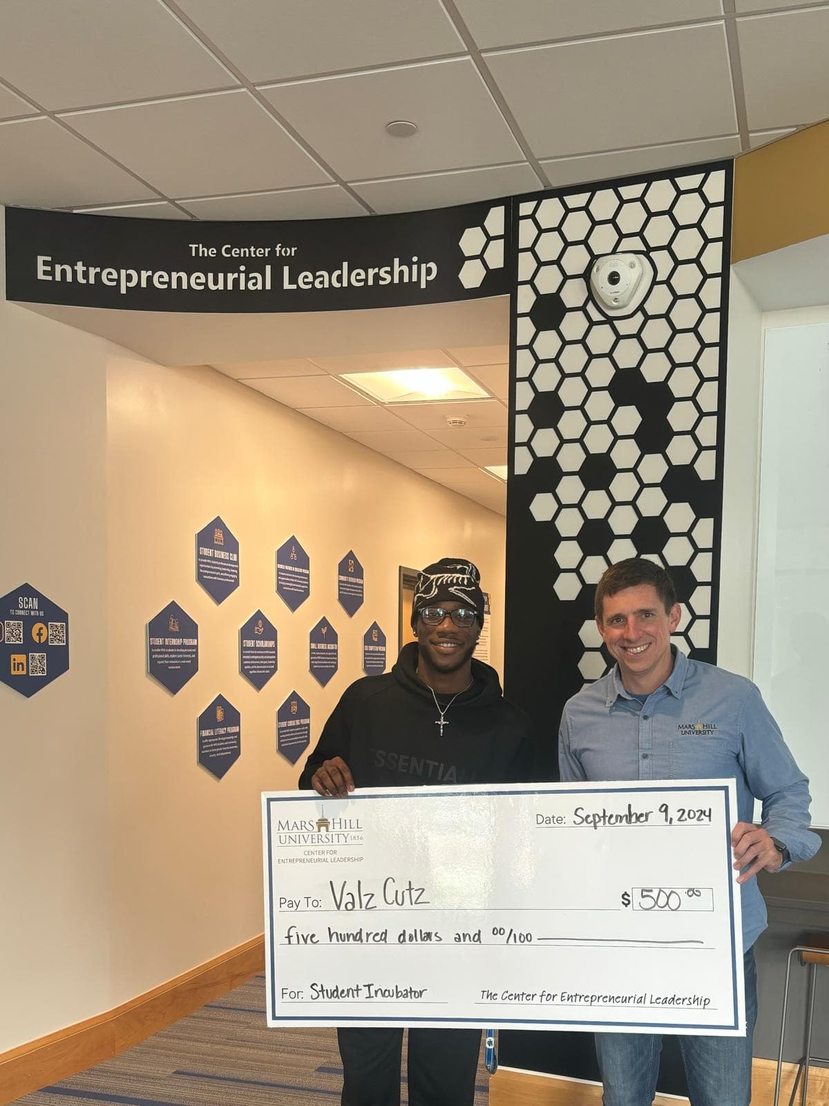 Valentino receiving a $500 Entrepreneurial Leadership grant